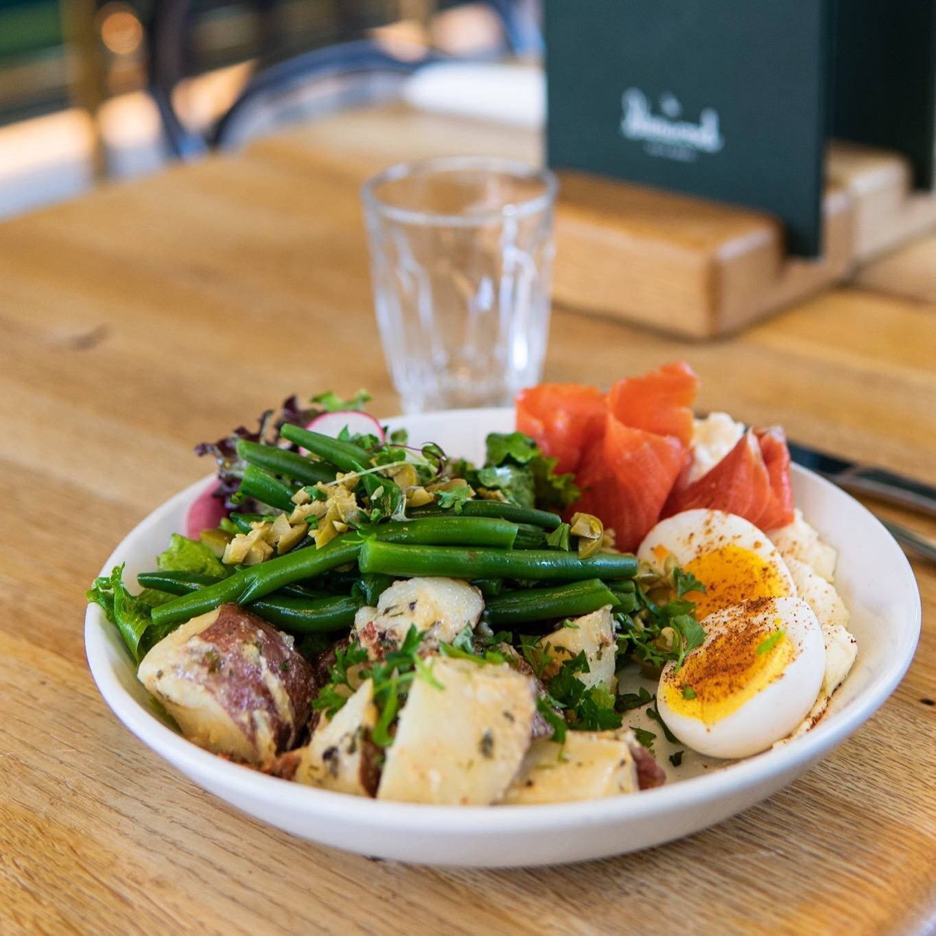 Have you tried our Ni&ccedil;oise salad? It is the perfect morning or early afternoon meal! House cured &amp; smoked sockeye, green beans, soft boiled egg, marinated fingerling potatoes, ricotta, olives, herbs, greens, and citrus dressing! ✨